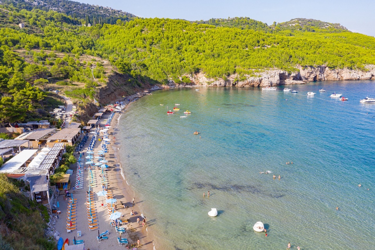 A family with children swimming and snorkelling from a small boat near Dubrovnik